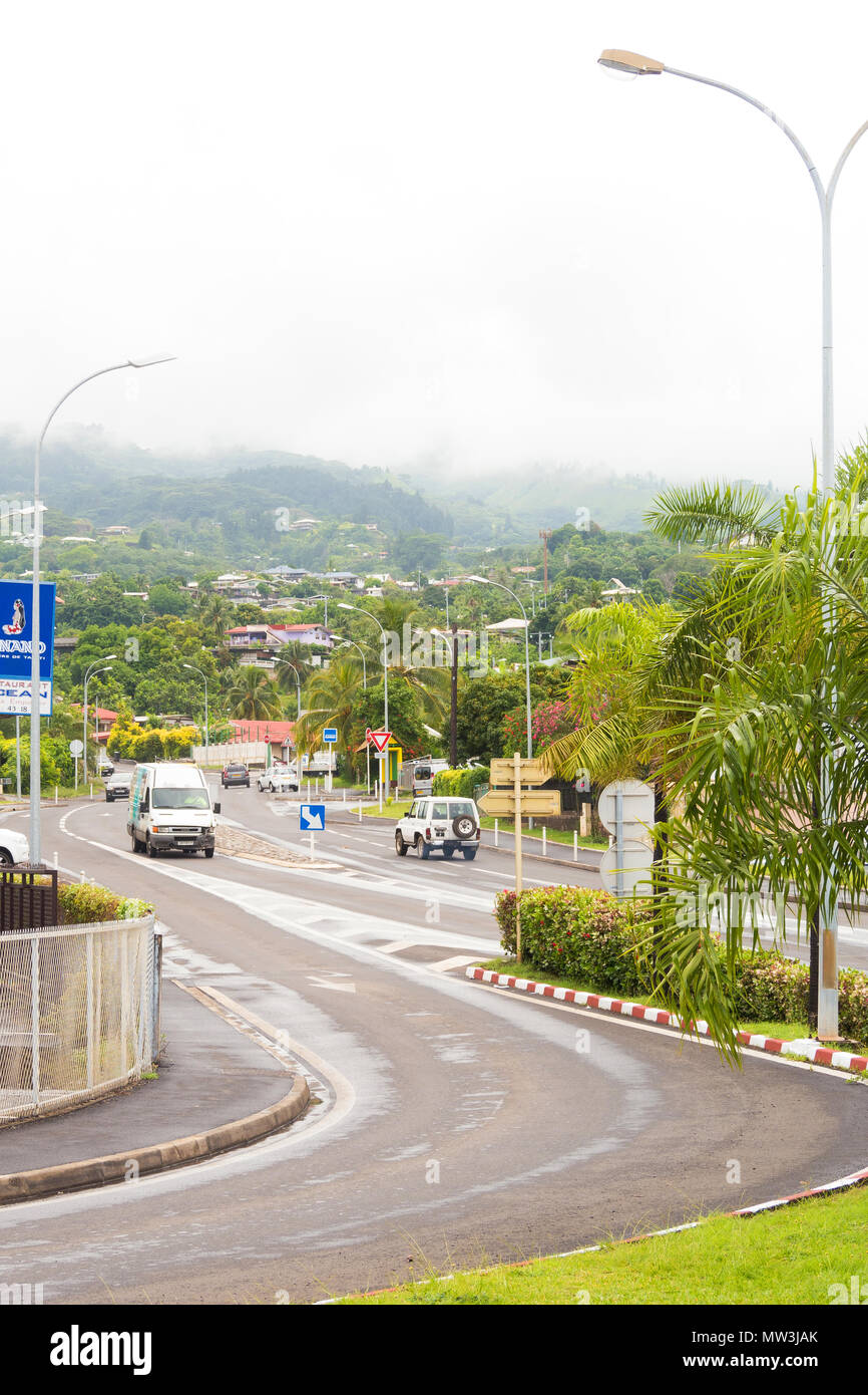 Cars drive along a winding street in Tahiti`s capital Papeete in French